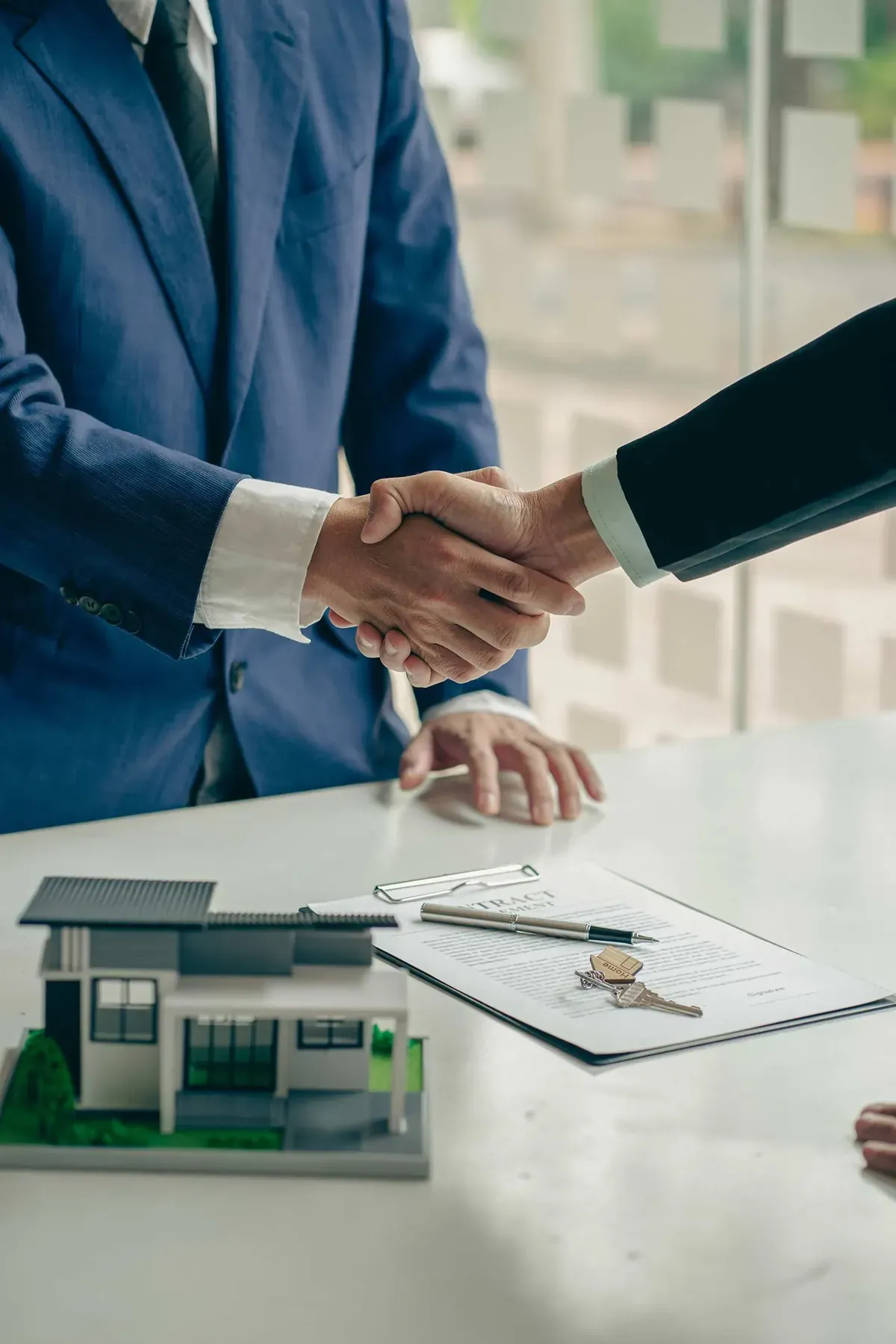 Professionals shaking hands over a property agreement