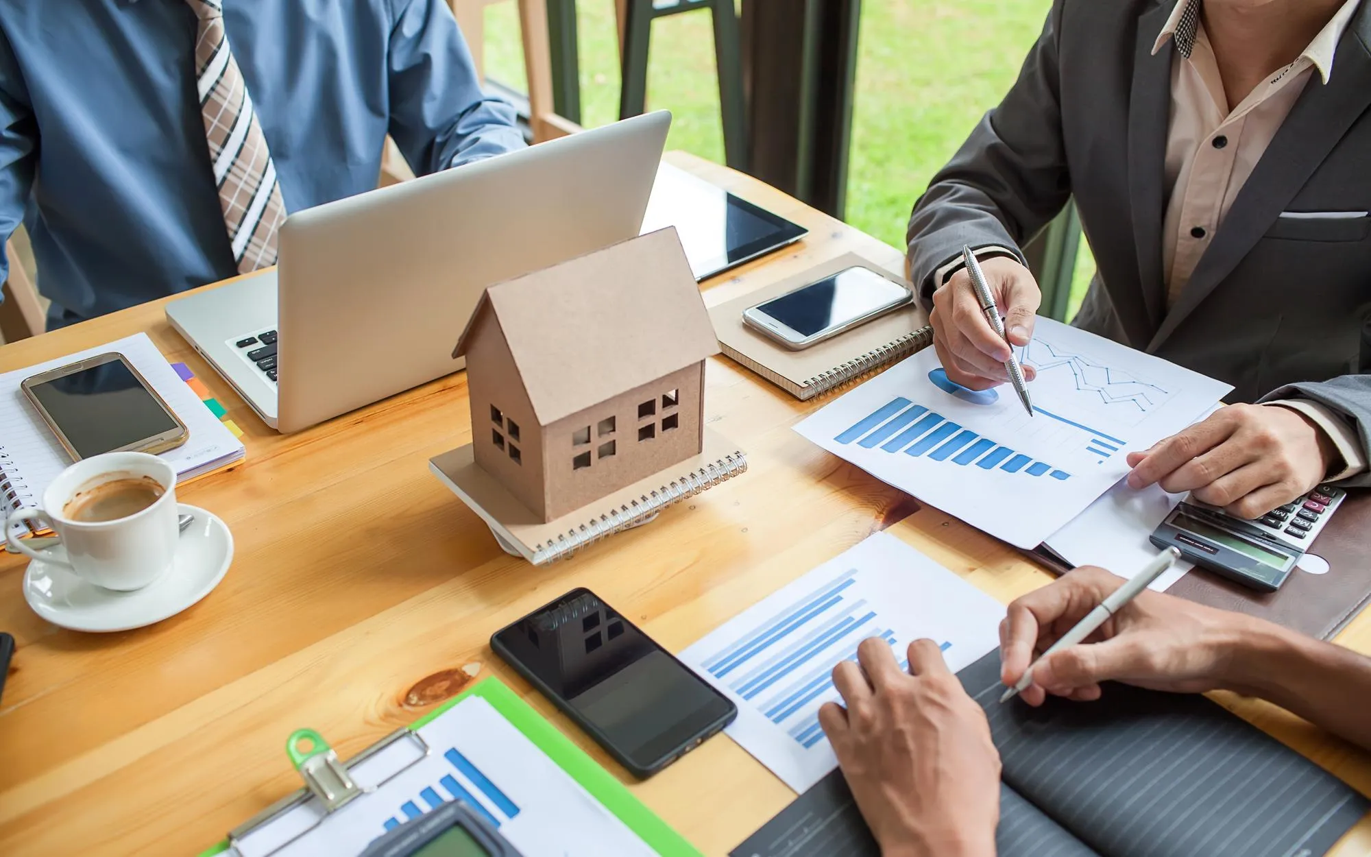 Professionals reviewing property figures around a table